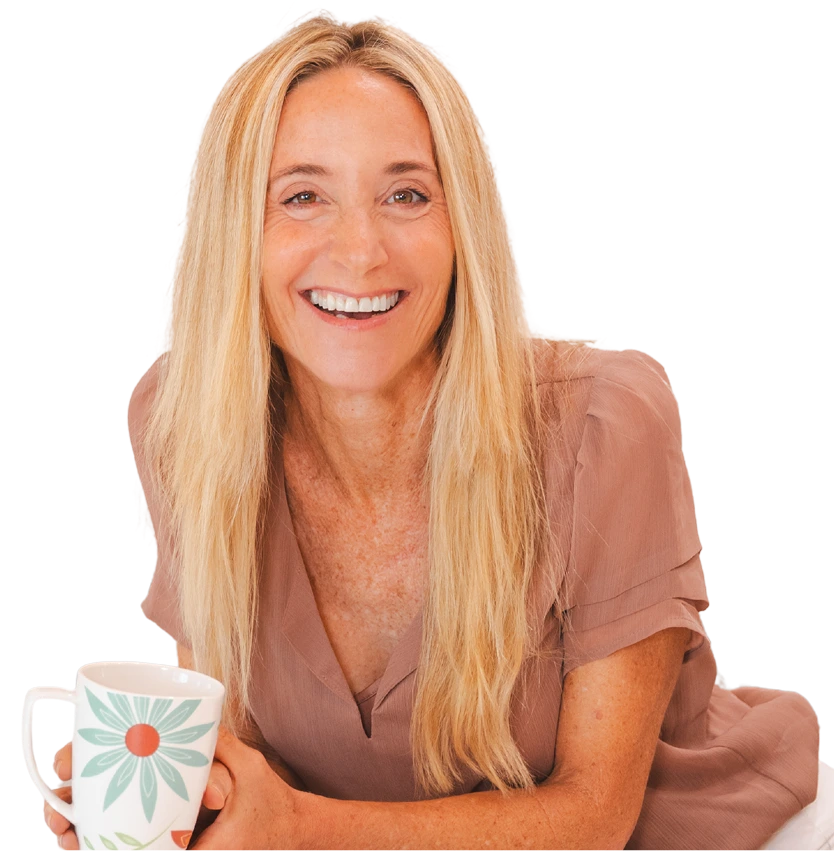Leslie Crisco smiling while holding her floral coffee mug.