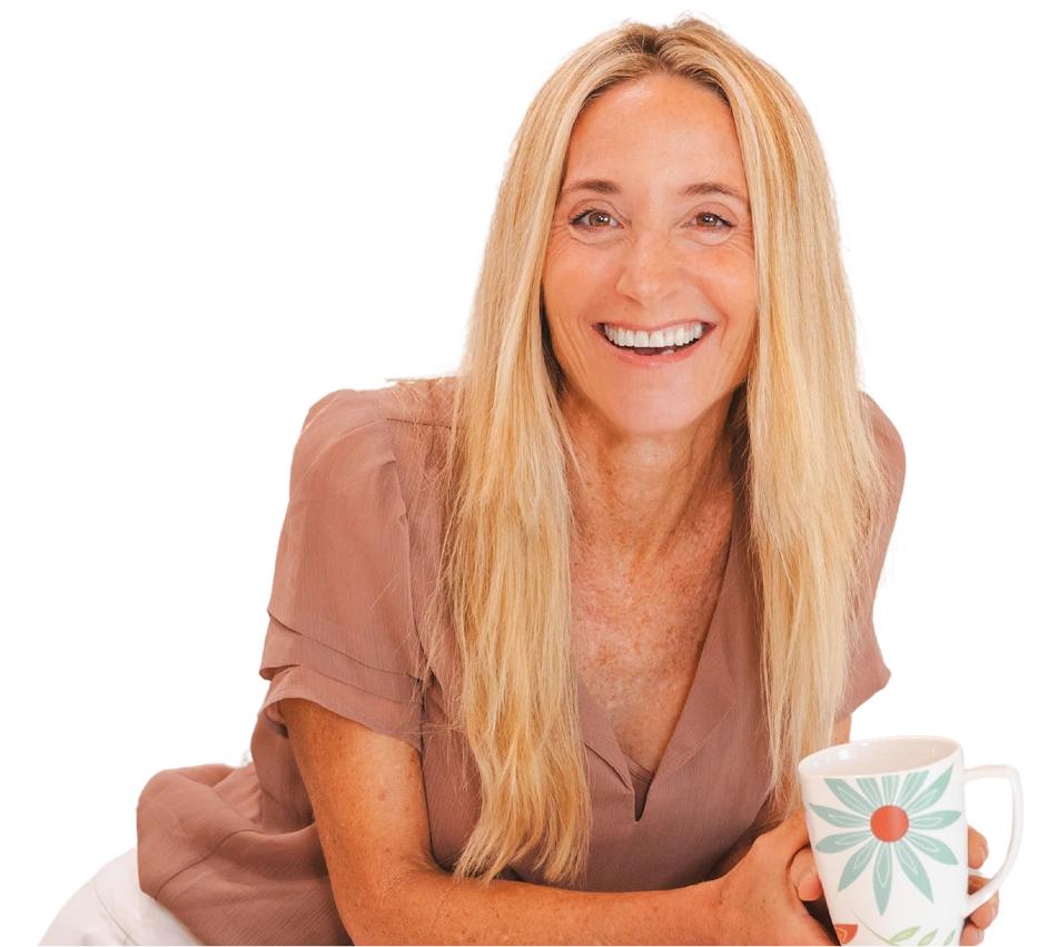 Leslie Crisco smiling while holding a floral coffee mug