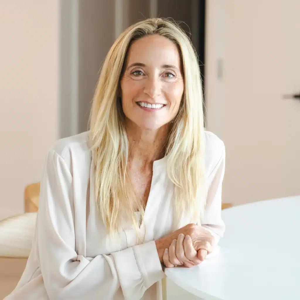 Leslie Crisco, RD sitting at a table smiling
