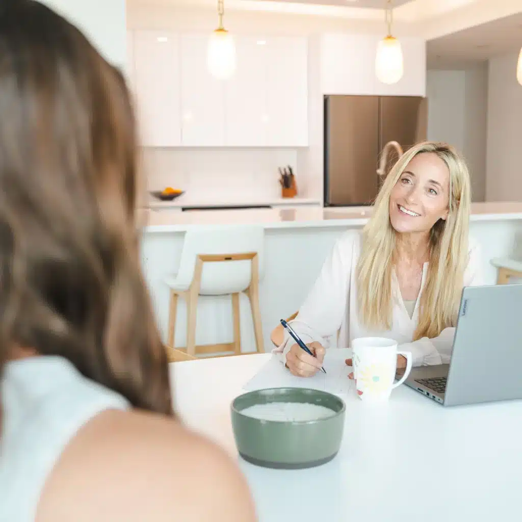 Leslie Crisco, RD sitting at a table with a client
